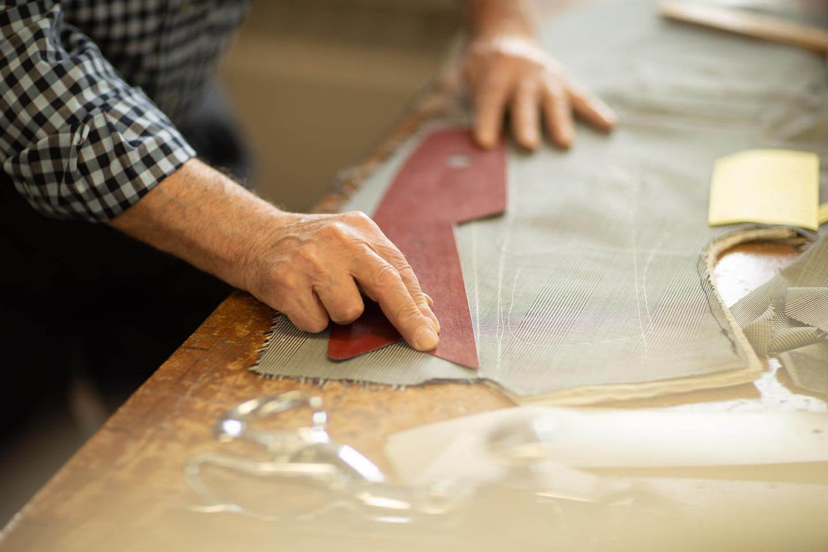 A pattern being positioned on checked tailoring cloth