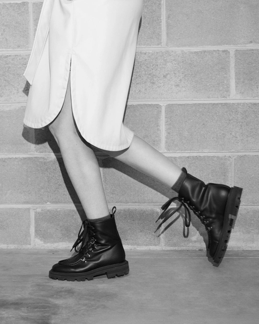AMALIA | Black - Lace-up Boots by AERA NEW YORK, luxury vegan shoes showcasing polished silver hardware and lug sole.