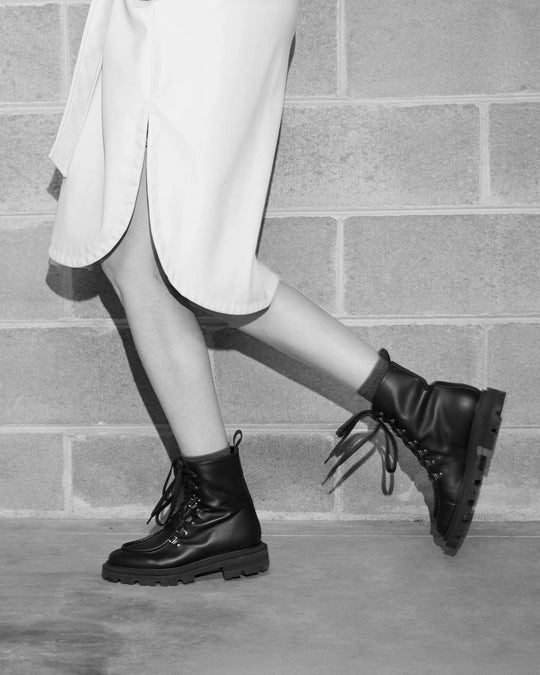 AMALIA | Black - Lace-up Boots by AERA NEW YORK, luxury vegan shoes showcasing polished silver hardware and lug sole.