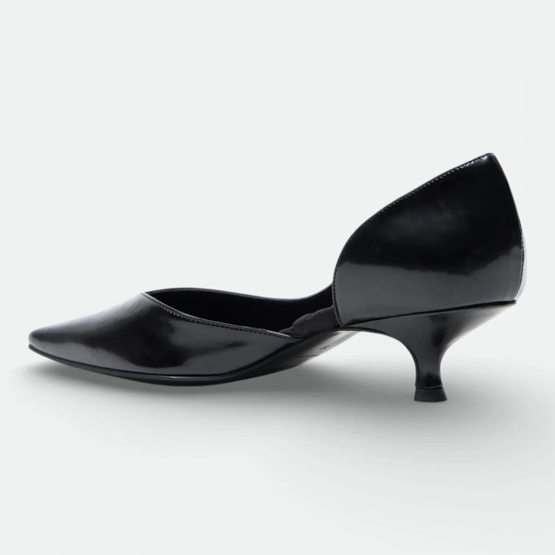 Black patent leather pointed-toe kitten heel shoe on white background