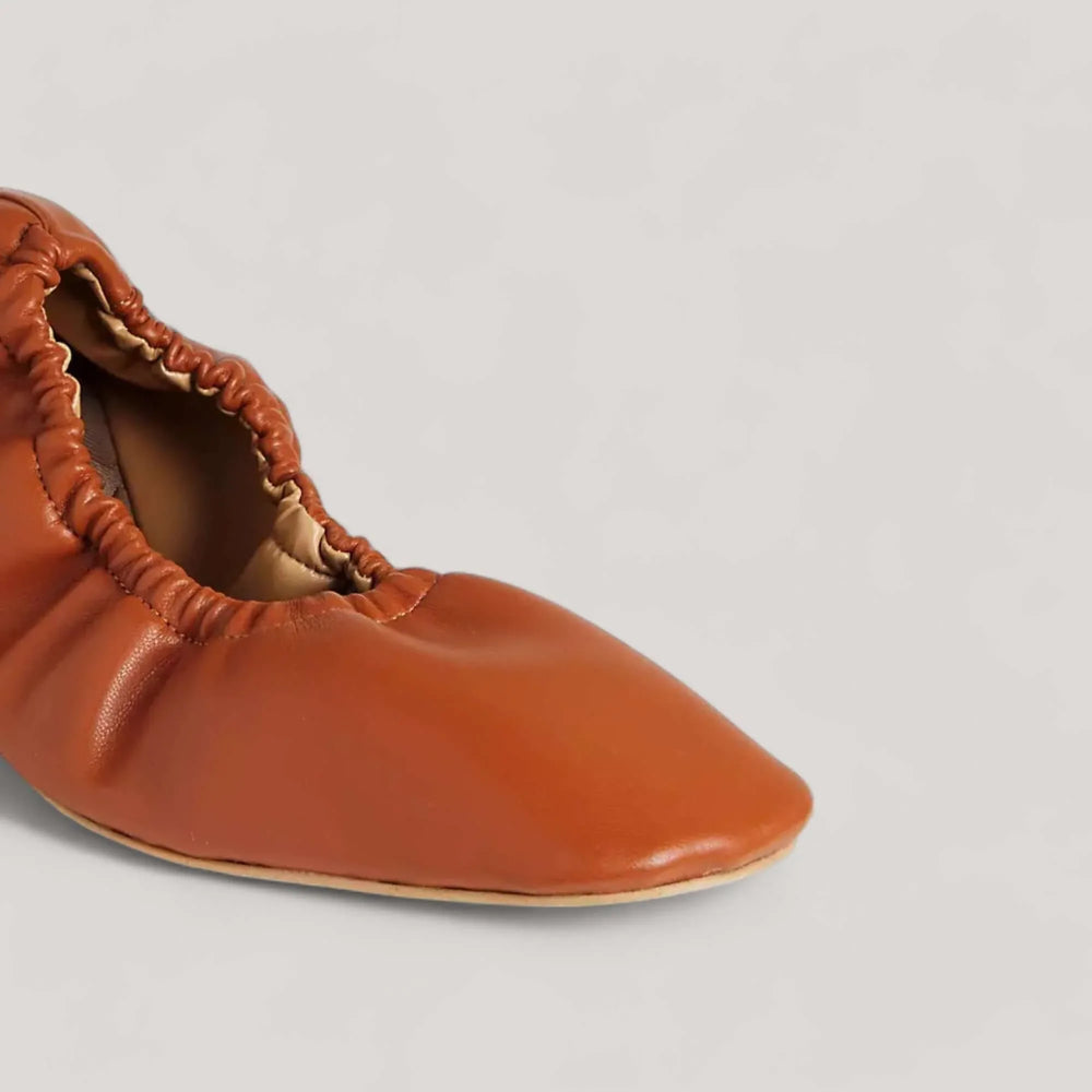 Tan vegan nappa ballet flat with elastic heel support and square toe design by AERA, handcrafted in Italy, featuring cushioned insole for comfort.