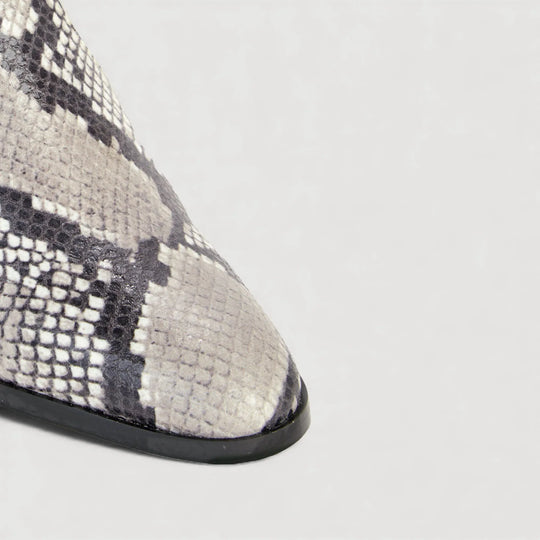 Close-up of STEFFY | Beige Faux-Snake Print - Ankle Boots by AERA NEW YORK, showcasing luxury vegan shoe design.