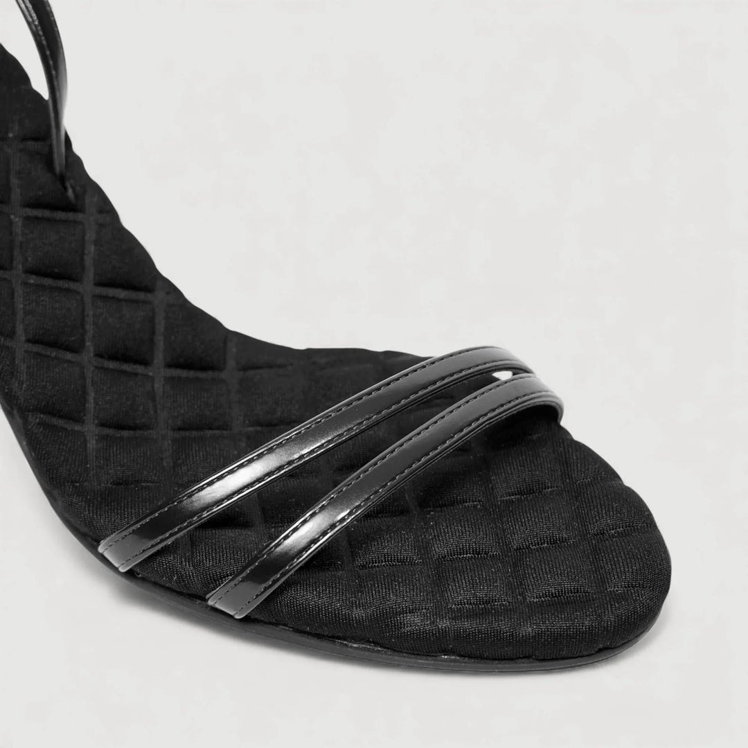 Close-up of LAURA | Black - Ankle Strap Sandal, showcasing quilted insole by AERA NEW YORK LUXURY VEGAN SHOES.