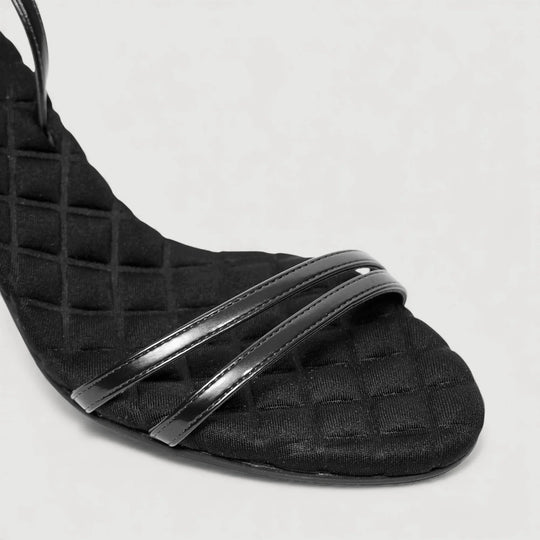 Close-up of LAURA | Black - Ankle Strap Sandal, showcasing quilted insole by AERA NEW YORK LUXURY VEGAN SHOES.