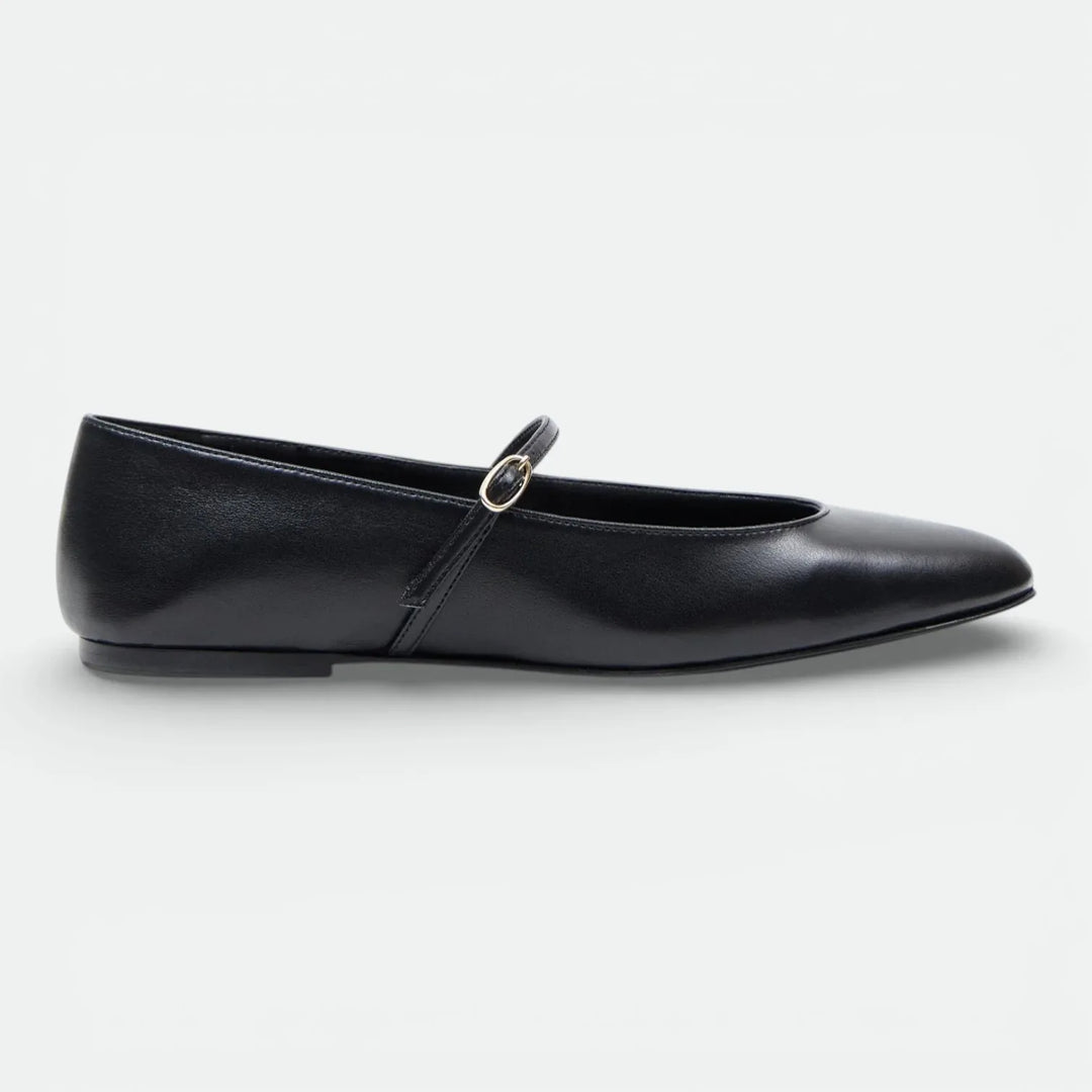 Black leather Mary Jane flat shoe with buckle strap on white background