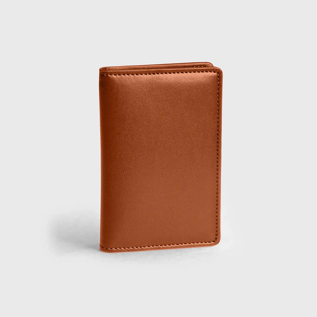 Premium burnt orange wallet in smooth leather, standing upright on a light background