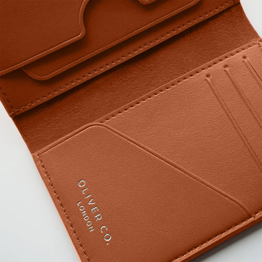 Burnt orange wallet with card slots and embossed text on interior