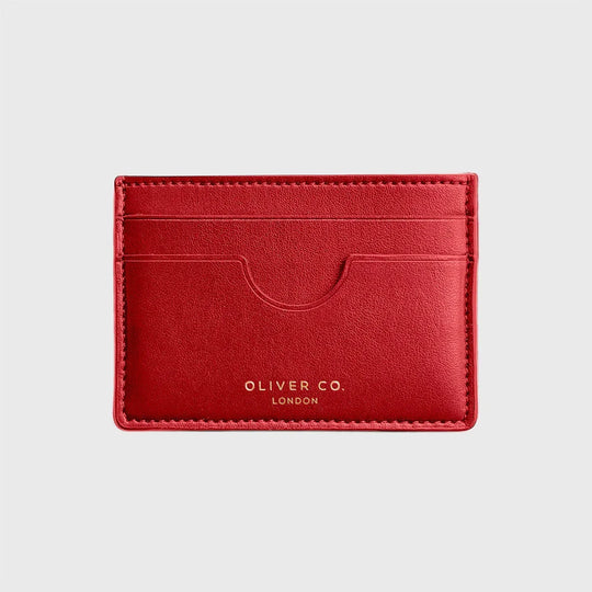 Slim red card holder wallet with front slots and gold text on light background