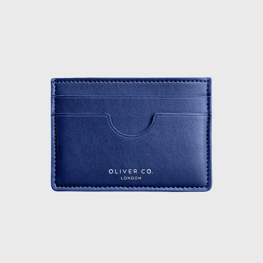 Slim cobalt blue card holder wallet with three card slots on a light background