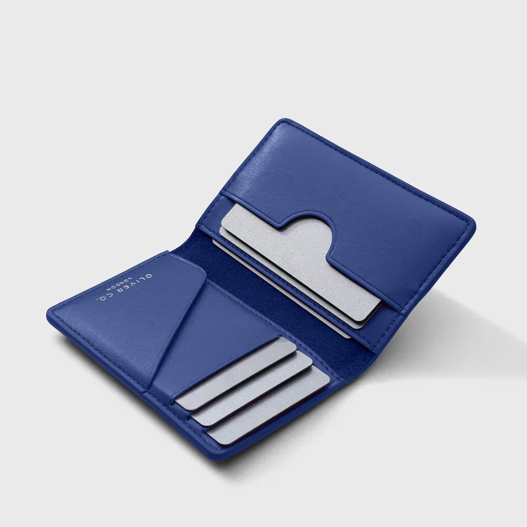 Open cobalt blue wallet with card slots on a light background