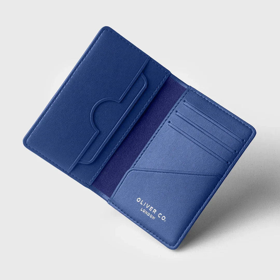 Open cobalt blue wallet with multiple card slots on a light background