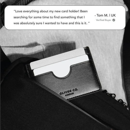 Slim black leather card holder with cards inside pocket, embossed with Oliver Co. London logo.