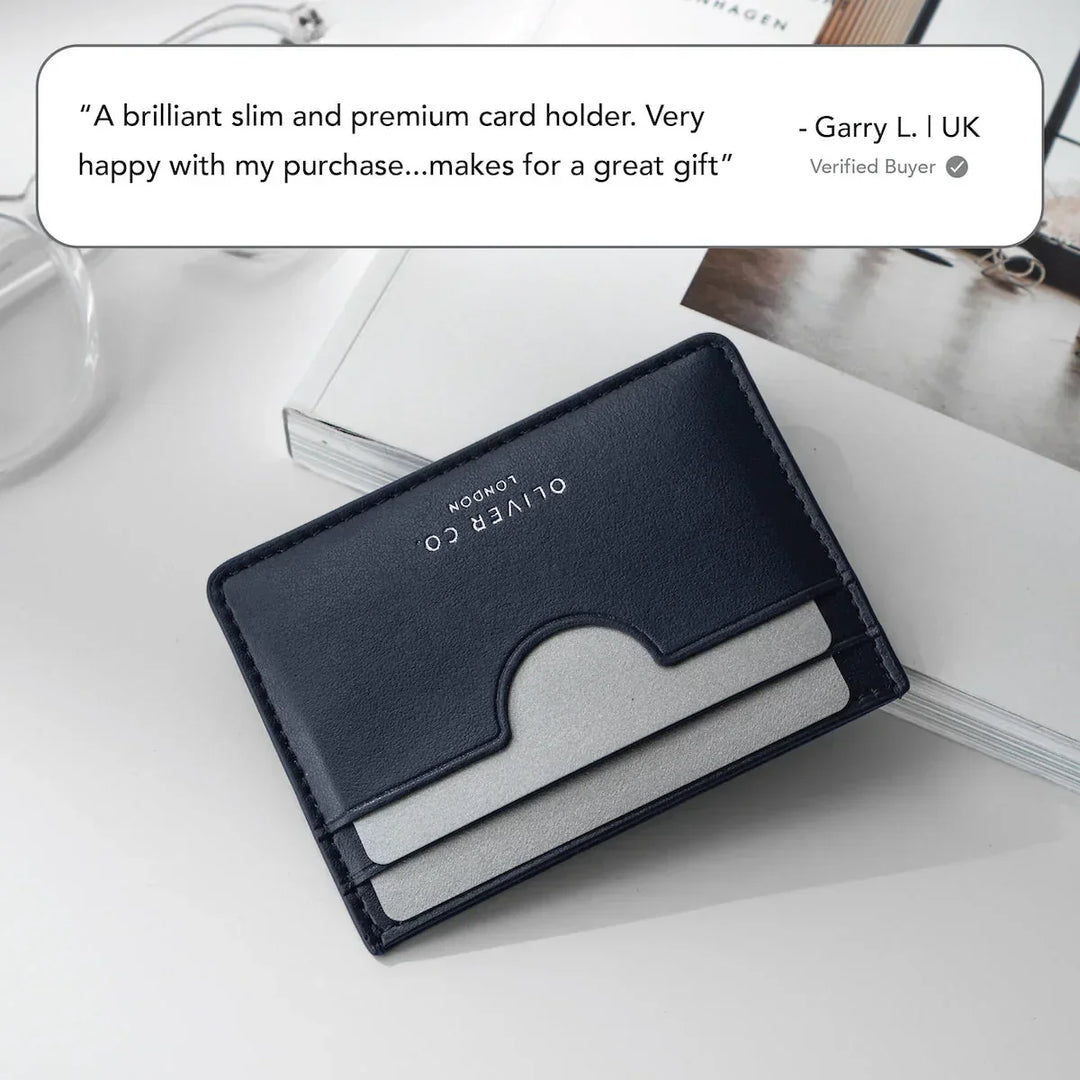 Slim premium leather card holder with gray cards on white desk, modern minimalist style