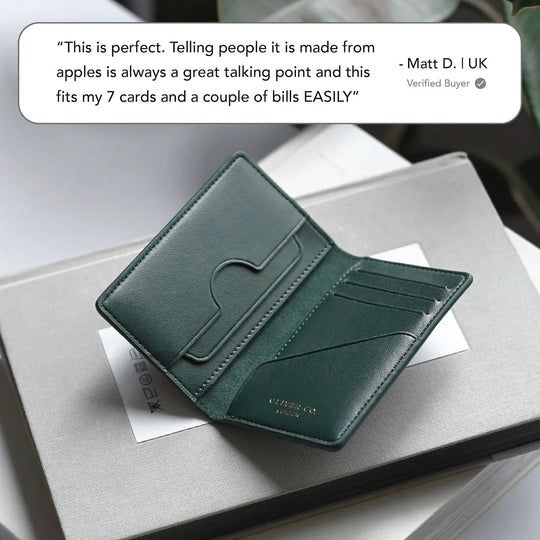Green compact vegan wallet with card slots, open on a book, modern minimalist style