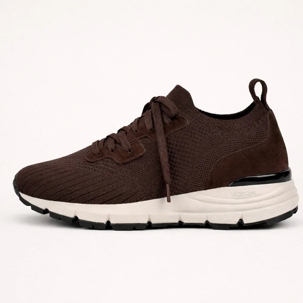 Brown suede and knit sneaker with white Vibram sole, side view on white background
