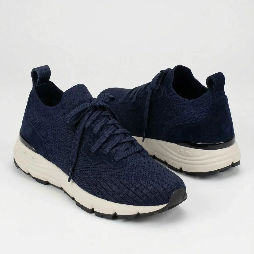Navy blue suede knit sneakers with white Vibram sole, side and front view on white background