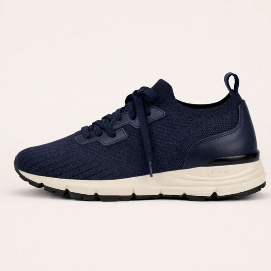 Navy blue suede knit sneaker with white Vibram sole and black outsole, side view