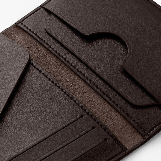 Close-up of a walnut brown compact wallet with multiple card slots and textured interior