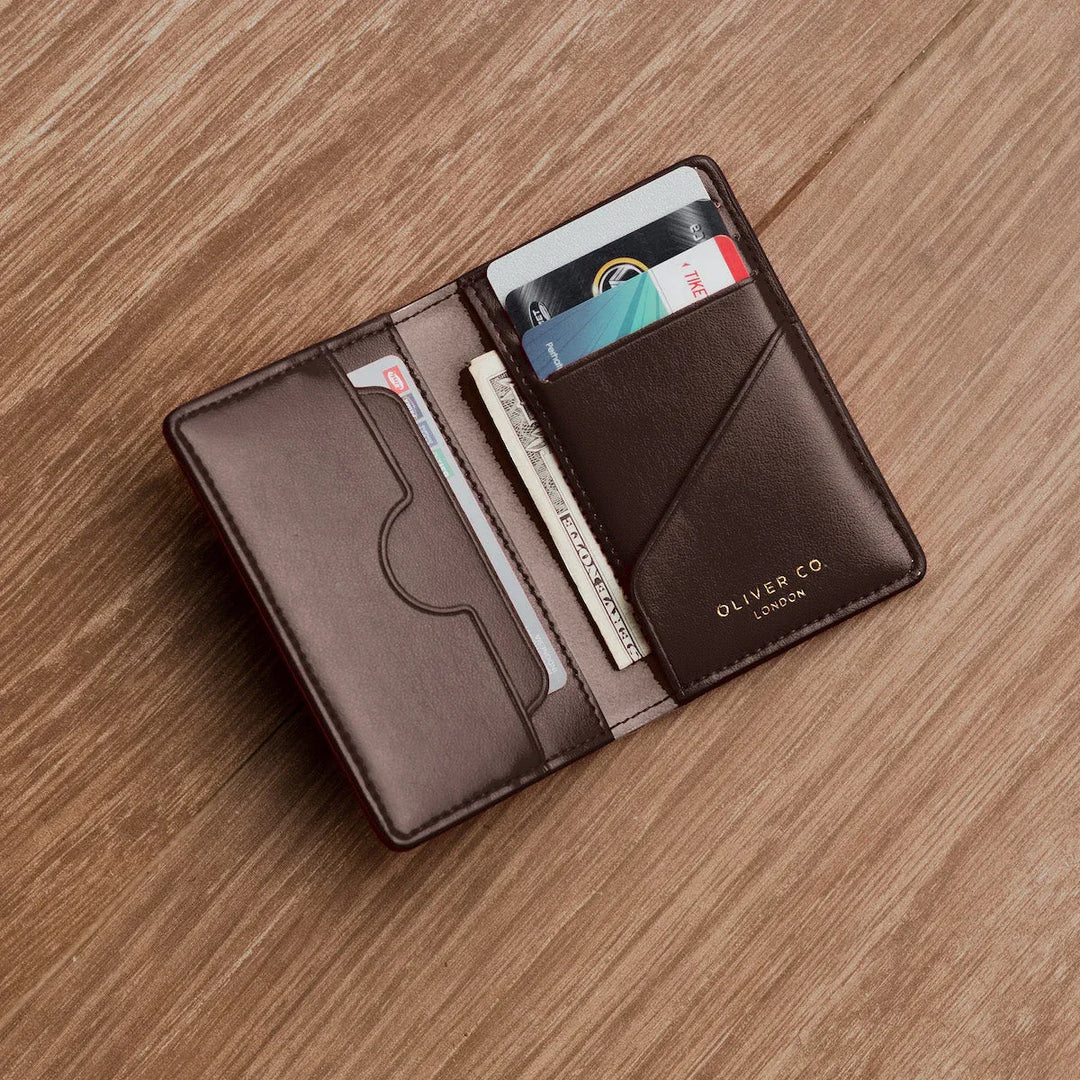 Walnut brown compact wallet open, showing card slots, cash, and premium leather texture