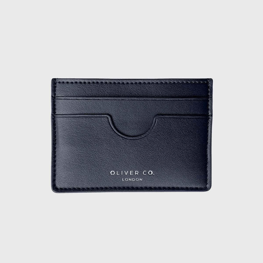 Black vegan slim card holder with card slots on a light background
