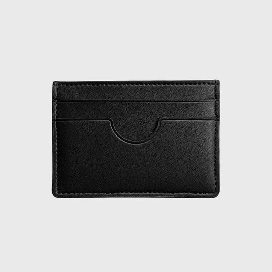 Black vegan slim card holder with multiple slots on a plain light background