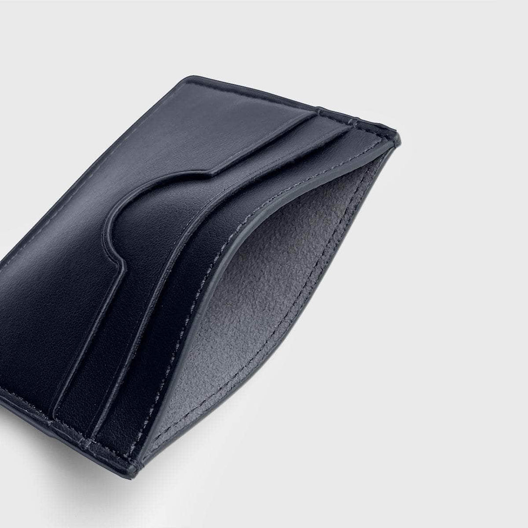 Slim black vegan card holder with clean stitching and minimalist design on light background