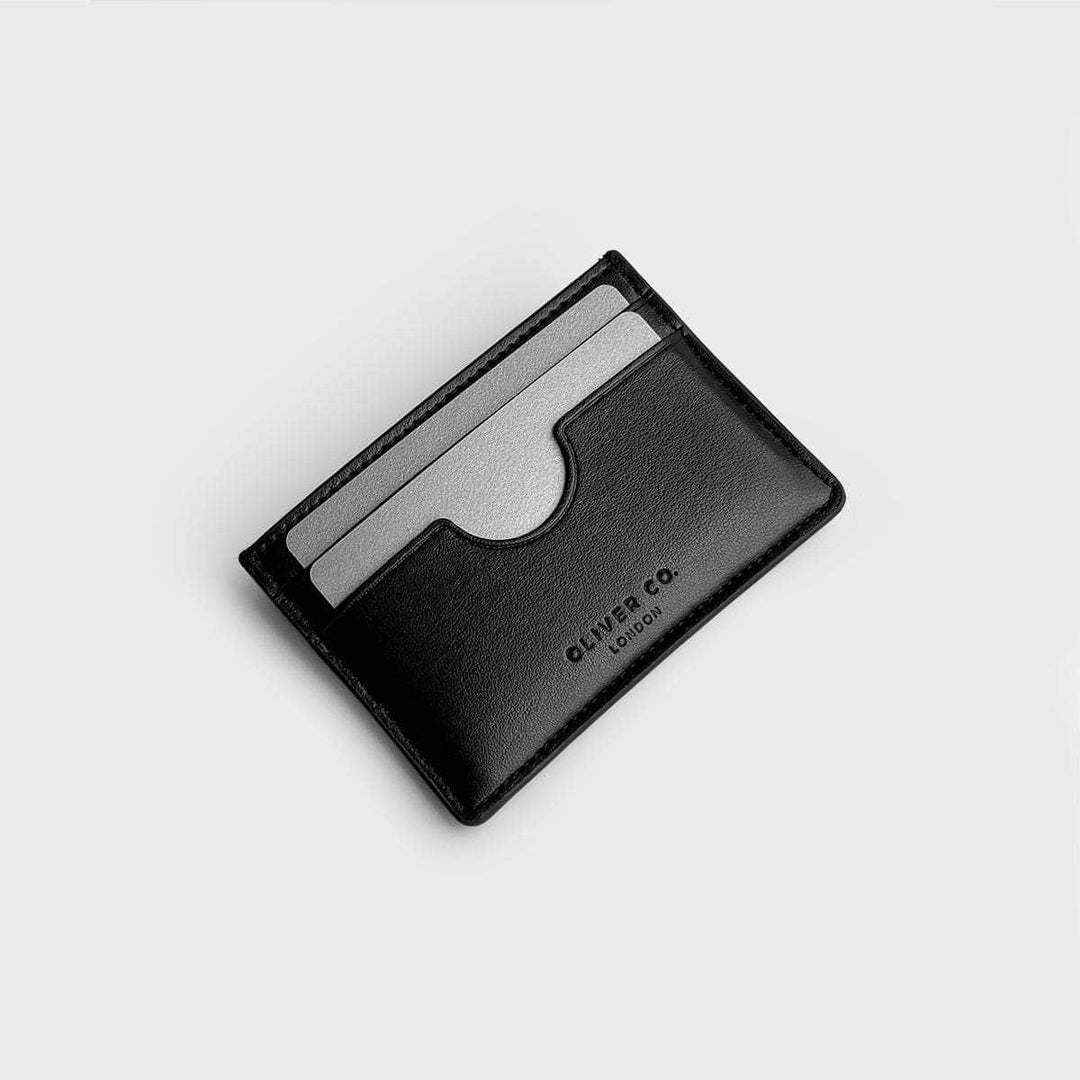 Black vegan slim card holder with two visible card slots on a light background
