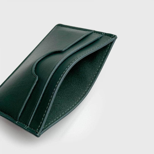 Green vegan slim card holder with minimalist design on light background