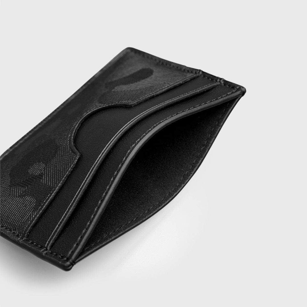 Slim black vegan card holder with multiple slots on a light background