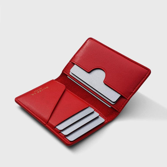 Open red vegan compact wallet with card slots on a light background